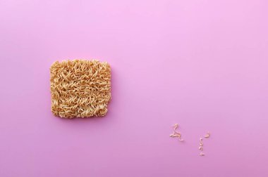 instant noodle on pink background with copy space