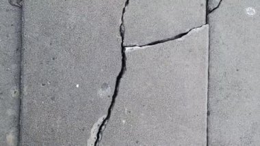 Cracked brick ground broken on street road from earthquake or not standard