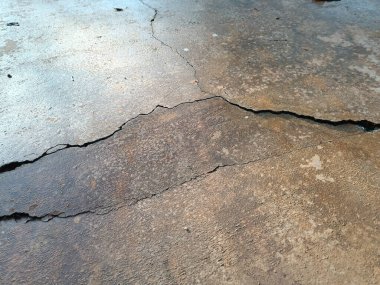 Cracked concrete ground broken at floor home or street road subside from earthquake