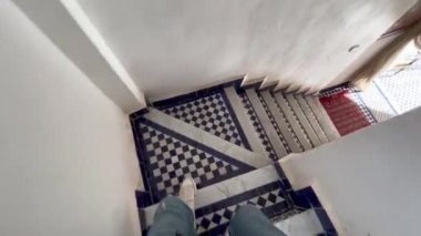 Fez 'in eski Medine' sindeki Faslı bir ayaklanmanın mozaik merdivenlerinde yürüyen tanınamayan bir gezgin.