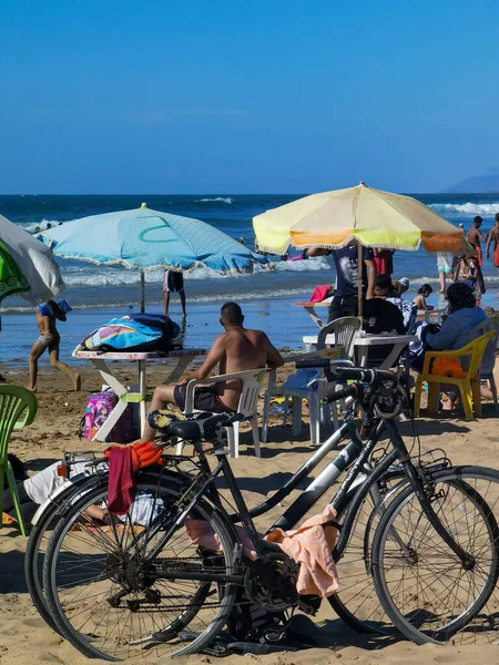 Pocas Bicicletas Una Playa Llena Gente Con Pocas Sombrillas Alrededor —  Fotos de Stock