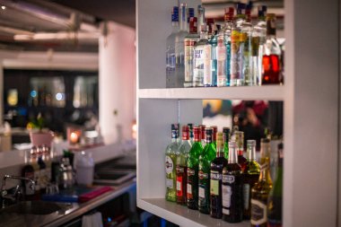 Restoran barının rafında farklı bir alkol şişesi var.