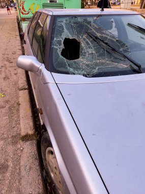 Dışarıdaki eski bir arabanın ön camı kırılmış.