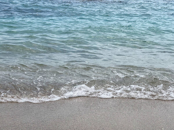 Peaceful seascape of the mediterranean sea with low waves on the coast