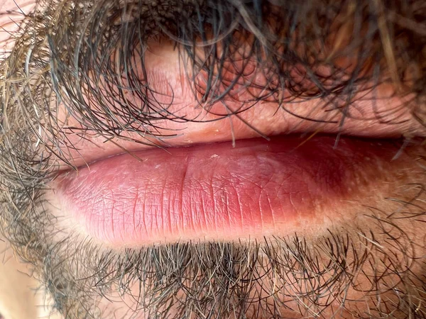 Close-up shot of a bearded man's lips