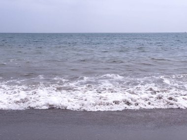 A gentle sea wave on a sandy beach