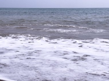 A gentle sea wave on a sandy beach