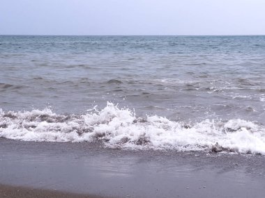 A gentle sea wave on a sandy beach