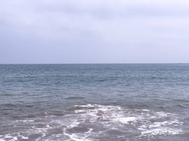 A gentle sea wave on a sandy beach