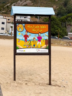 Signboard requesting from people to keep the sea sand clean