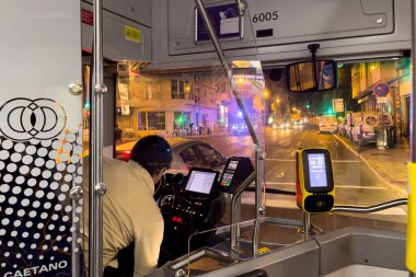 Lizbon 'da gece vakti otobus süren bir adam.