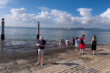 Lizbon 'da bir tekne rampasında duran insanlar.