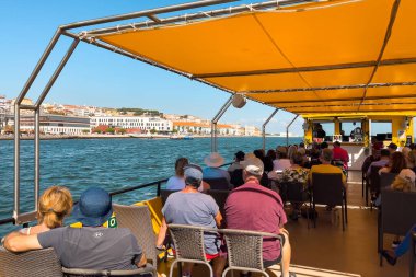 Bir grup turist Lizbon 'da bir tur teknesine biniyor.