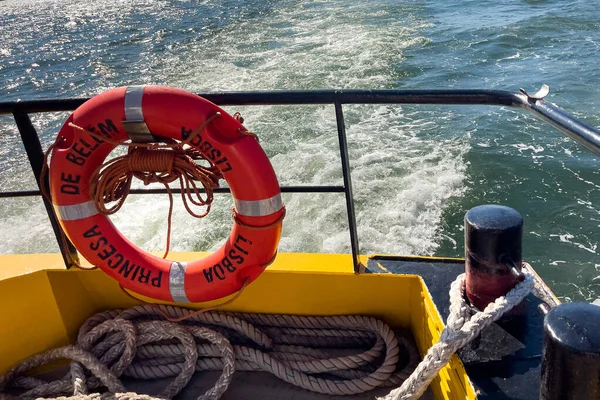 Orange rescue ring on a ferry boat in Lisbon