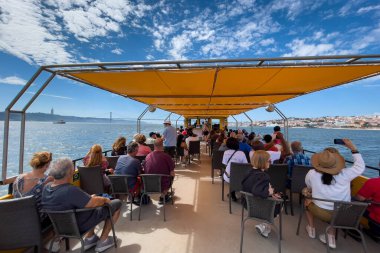 Bir grup turist Lizbon 'da bir tur teknesine biniyor.