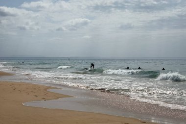 İnsanlar Carcavelos, Portekiz sahillerinde eğleniyorlar.
