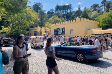 Turistler Sintra Ulusal Sarayı 'na girmek için kuyrukta bekliyorlar.