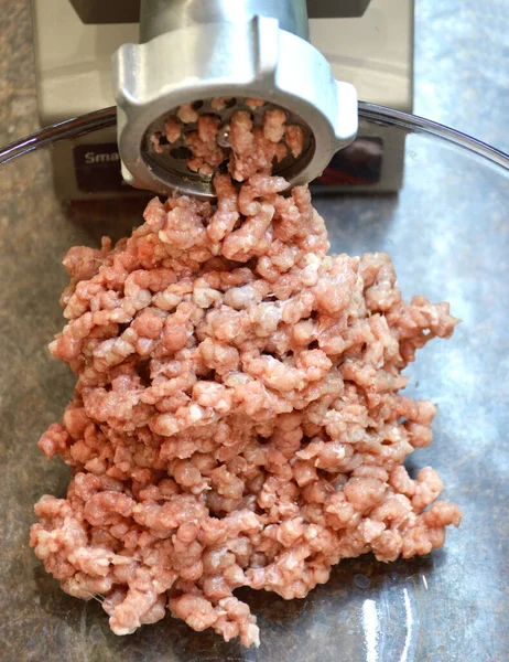 minced meat from an electric meat grinder in the home kitchen. grinding meat into minced meat for the preparation of semi-finished products