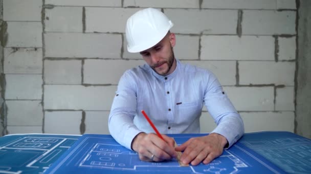 Construction engineer draws a building plan