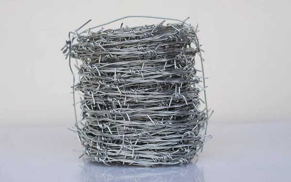 Roll of barbed wire. Barbed wire is used for make fences , secure property and make border to show the territory of  area.          