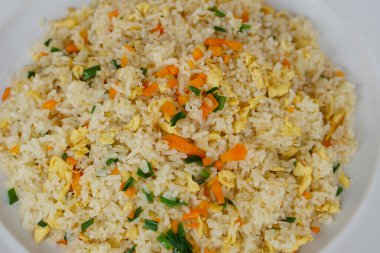 Closeup Thai homemade fried rice food on plate, mixed eggs, carrots and spring onion. Concept : Traditional Thai food. Easy and popular menu, can cook at home, restaurant.     