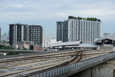 Bangkok, Thailand - August 5th, 2022 : MRT Sky Train railway route in city with skyscraper buildings background.  