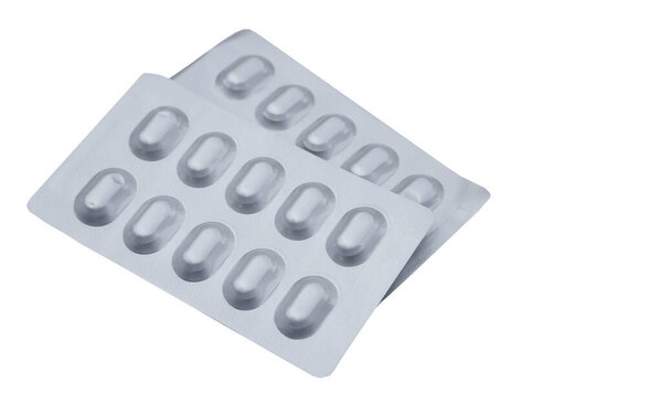 Silver aluminum blister packages of capsule pills medicine isolated on white background. Concept : Pharmaceutical packaging manufacturing medicine. Pharmacy.