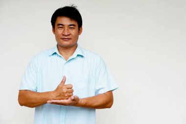 Handsome Asian man deaf teacher demonstrates body sign language on white background. Concept : Sign Language to teach or communicate with deaf disabled. Education for handicaps .                   