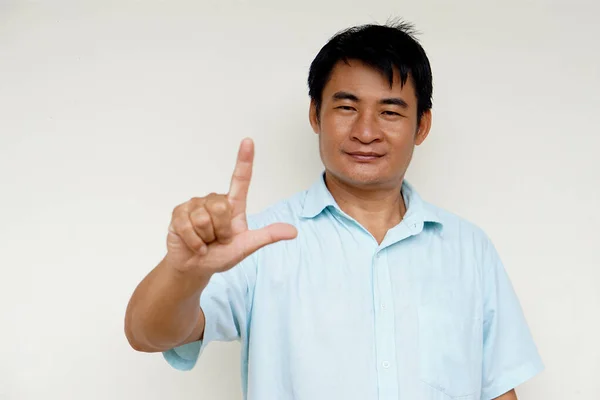 Asian man teacher demonstrate body sign language on white background. Point index finger up. Concept : Sign Language to teach or communicate with deaf disabled. Education for handicaps. Translator