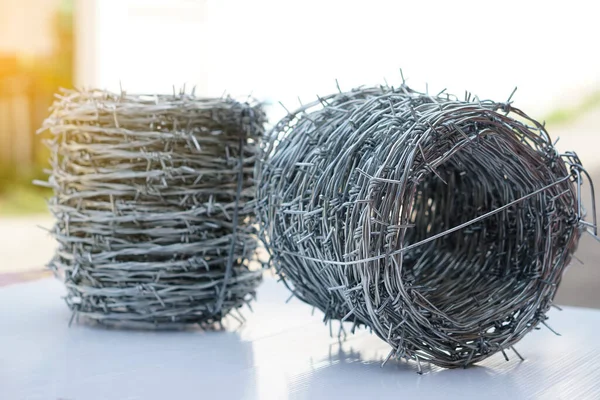 Rolls of barbed wire. Barbed wire is used for make fences , secure property and make border to show the territory of  area.