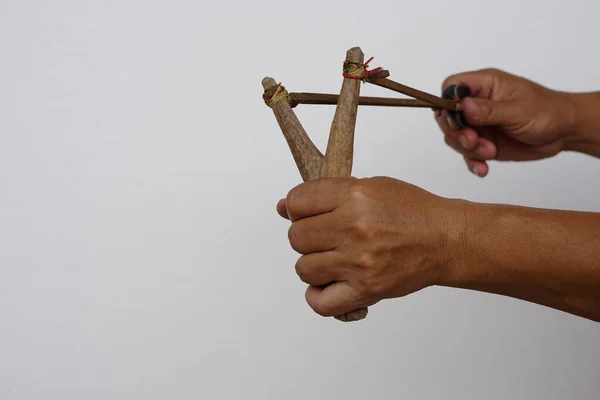 Shooting slingshot isolated on gray background. Concept : Thai traditional weapon that use to shoot birds, fish , for fight  game or other purposes.