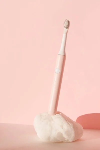 New modern ultrasonic toothbrush. Dental care supplies on white stone on pink pastel background. Oral hygiene, dental and gum health, healthy teeth. Dental products Ultrasonic vibration toothbrush. — Stock Photo, Image