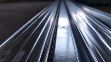 Metal profiles. Stack of stainless steel pipes in warehouse. Rolled metal products. Economic Metals list prices index. Financial crisis. Wall building parts.