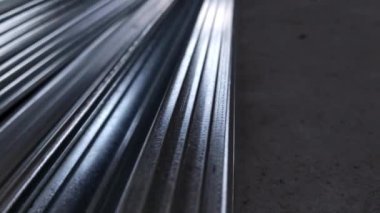 Metal profiles. Stack of stainless steel pipes in warehouse. Rolled metal products. Economic Metals list prices index. Financial crisis. Wall building parts.