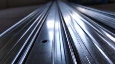 Metal profiles. Stack of stainless steel pipes in warehouse. Rolled metal products. Economic Metals list prices index. Financial crisis. Wall building parts.