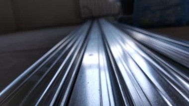 Metal profiles. Stack of stainless steel pipes in warehouse. Rolled metal products. Economic Metals list prices index. Financial crisis. Wall building parts.