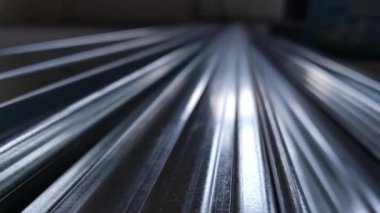 Metal profiles. Stack of stainless steel pipes in warehouse. Rolled metal products. Economic Metals list prices index. Financial crisis. Wall building parts.