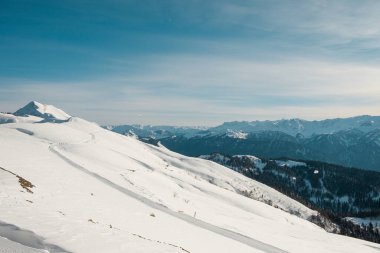 Winter mountains panorama with ski slopes and ski lifts on a sunny day. Ski resort, lift, mountains wide panoramic background