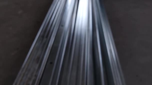 Metal profiles. Stack of stainless steel pipes in warehouse. Rolled metal products. Economic Metals list prices index. Financial crisis. Wall building parts. — Stock video