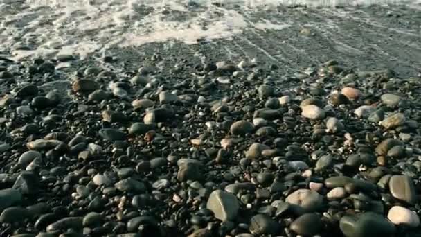 Sea Waves On Beach Pebbles, beautiful close-up footage of a sea waves washing up beach pebbles. Pebble colorful coastline, horizontal. Waves are reaching pebble beach — Stockvideo