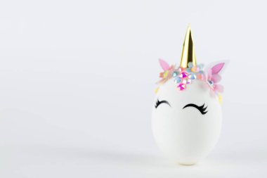 Easter unicorn egg isolated on white background. Happy easter banner. Kids activity inspiration. Greeting card or poster. Copy space for text