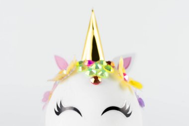 Easter unicorn head egg isolated on white background. Happy easter banner. Kids activity inspiration. Greeting card or poster. Copy space for text