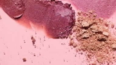 Cosmetics swatches. Peach, beige, red and coral toned styled cosmetics flat lay. Closeup lipstick and shadows colour palette. Creative concept cosmetics samples. Beauty products on pastel background