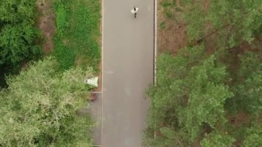 Aerial dron top down view of Running Handsome Man in morning green park. Endurance Workout Training. Runner Fit Athlete. Leg Jogging Exercise. Jogger Fitness Sport Run. Summer activities concept.
