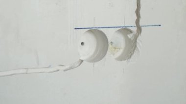 Strobe line for laying electric cable. Wiring repair and replacement concept. Plastered walls of the room with strobes for electrical wiring for installing wiring accessories.