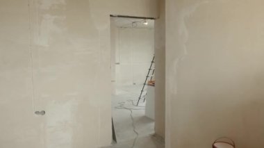 Renovation apartment. Empty walls, repairs house with their own hands. Interior of the apartment without decoration in gray colors. Concept of home refurbishment.