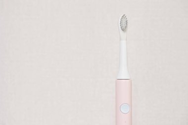 New modern ultrasonic toothbrush. Jaw model and dental care supplies on gray background. Oral hygiene, dental and gum health, healthy teeth. Dental products Ultrasonic vibration toothbrush