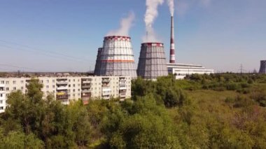 Combined heat and power CHP plant. Thermal power. Residential heat supply. Water cooling towers, big steam and smoke pipes. Thermal power plant aerial 4k view 