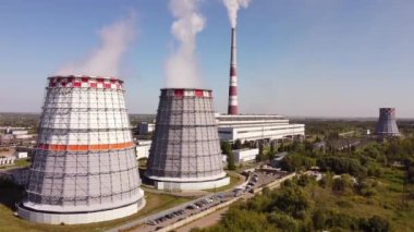 Combined heat and power CHP plant. Thermal power. Residential heat supply. Water cooling towers, big steam and smoke pipes. Thermal power plant aerial 4k view 