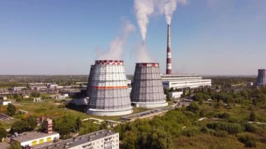 Combined heat and power CHP plant. Thermal power. Residential heat supply. Water cooling towers, big steam and smoke pipes. Thermal power plant aerial 4k view 